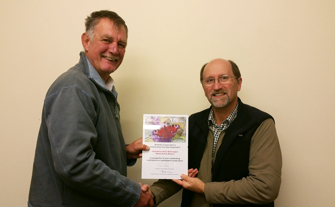 Mike Slater (left) hands over the Outstanding Volunteer Award to Keith Warmington during a Warwickshire Branch Committee Meeting in 2015.